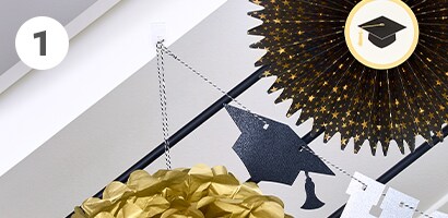 arranging the garland and other graduation party design and decor
