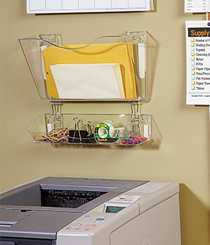 Next, use Command™ Picture Hanging strips to hang up clear plastic caddies to hold items such as envelops, rubber bands, binder clips, tape and push pins
