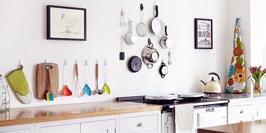 Command products inspiration for diy home organizing projects like hanging pots, pans, and spatulas on the wall.