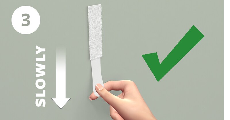 Step 3 of removing Command™ strips

