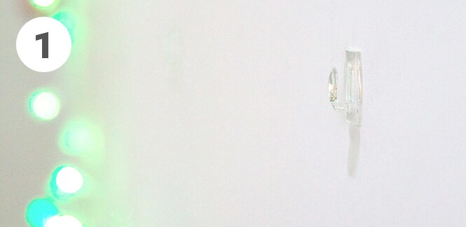 Command™ Adhesive Strips on the wall next to the fairy lights
