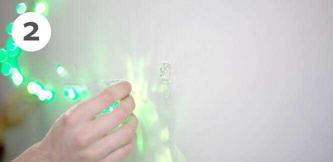 Command™ Clear Mini Hooks to hold the Christmas tree lights on the wall
