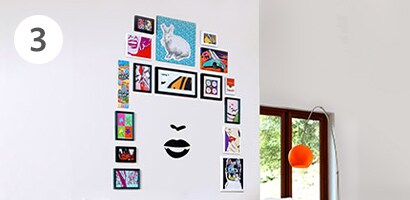Unique gallery wall at home featuring a face wall decal
