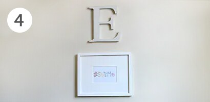 Letter E monogram on top of a selfie image framed with command picture hanging strips
