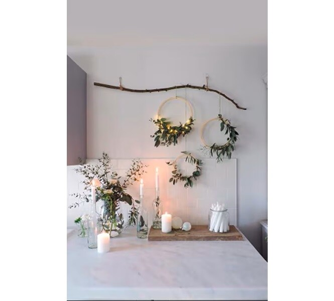 Green branches and holiday sprigs displayed in the kitchen