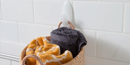 image of 3m command hooks in the bathroom range used to hang towels in a basket