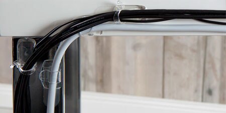 image of well-organised cords on the table with the help of command cord clips, organisers, and bundlers
